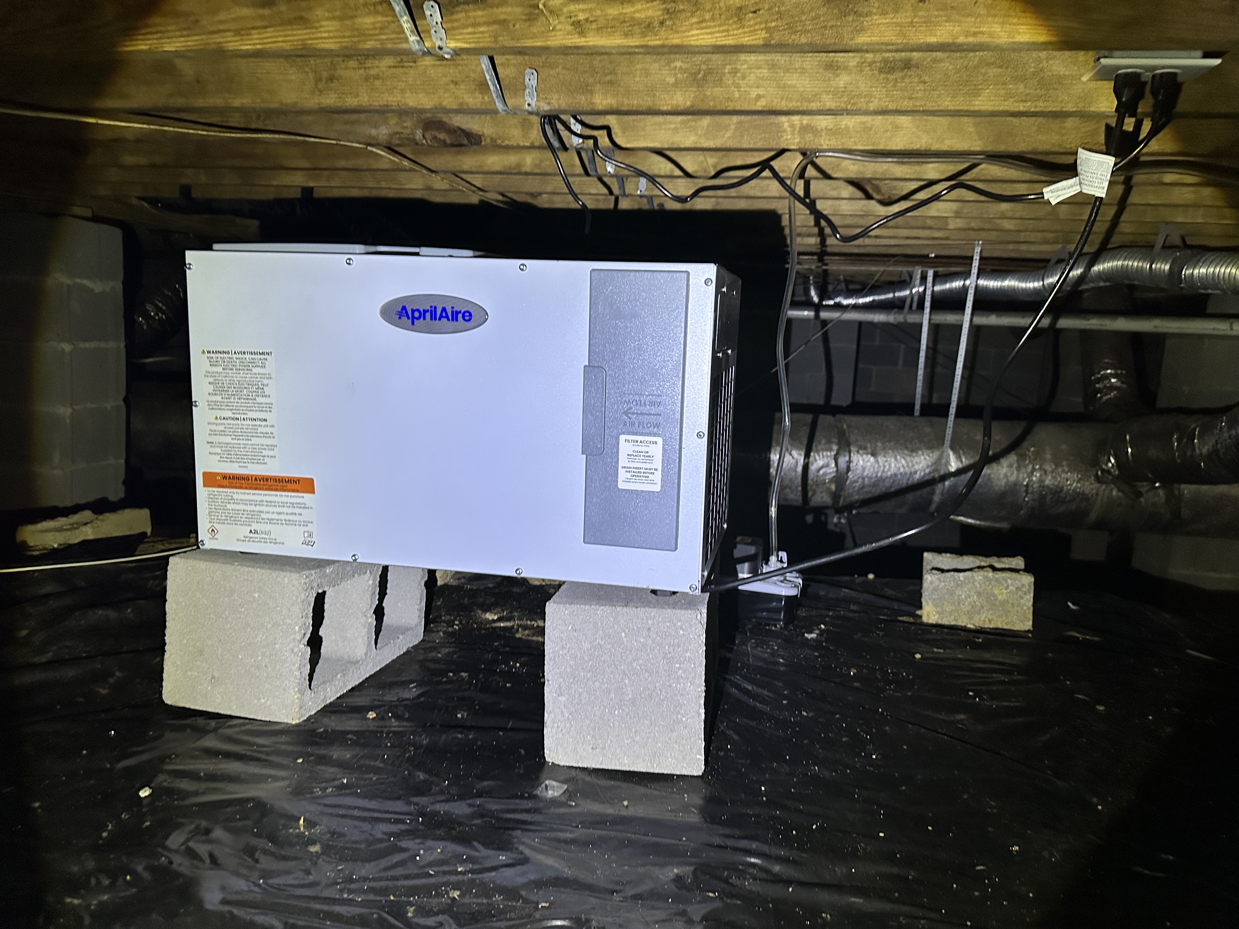 Aprilaire commercial dehumidifier installed in Nashville crawlspace with vapor barrier