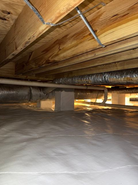 Crawl space encapsulation with liner wrapped up the piers