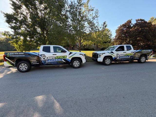 Two CrawlSpace Experts service trucks parked on a Middle Tennessee street